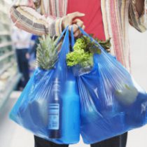 Man looking at bill in grocery store