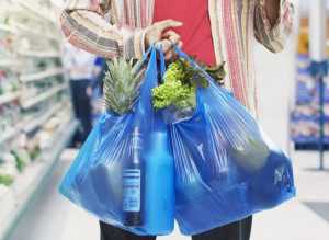 Man looking at bill in grocery store